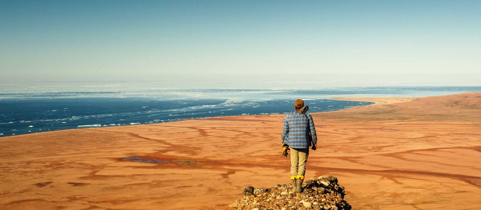 Overlooking the Northwest Passage, Nunavut Man overlooking Red Beach and the Northwest Passage in the Arctic