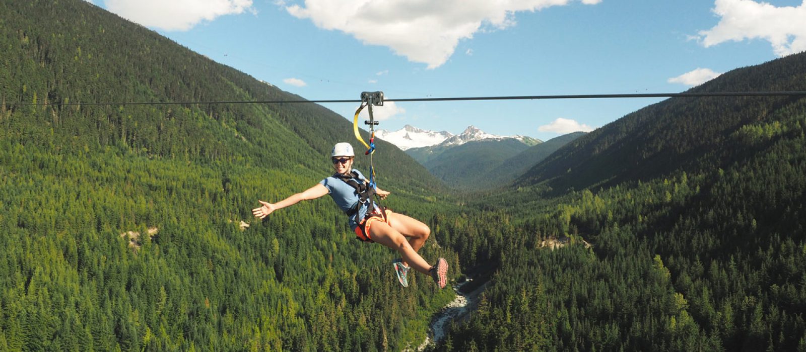 Ziplining with Ziptrek Ecotours Whistler, British Columbia Woman ziplining high in the air in Whistler on Ziptrek Ecotours Sasquatch Line